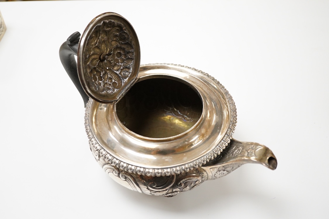 A late George III silver circular teapot, by Samuel Hennell, London, 1818, with later embossed decoration, gross weight 26.9oz.